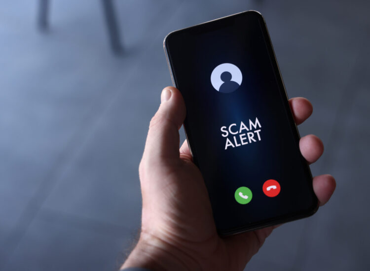 Scam alert on mobile phone screen